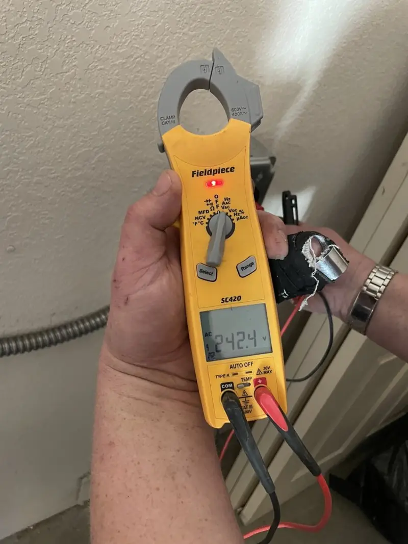 Voltage testing with clamp meter during Recessed Lighting Installation in North Versailles